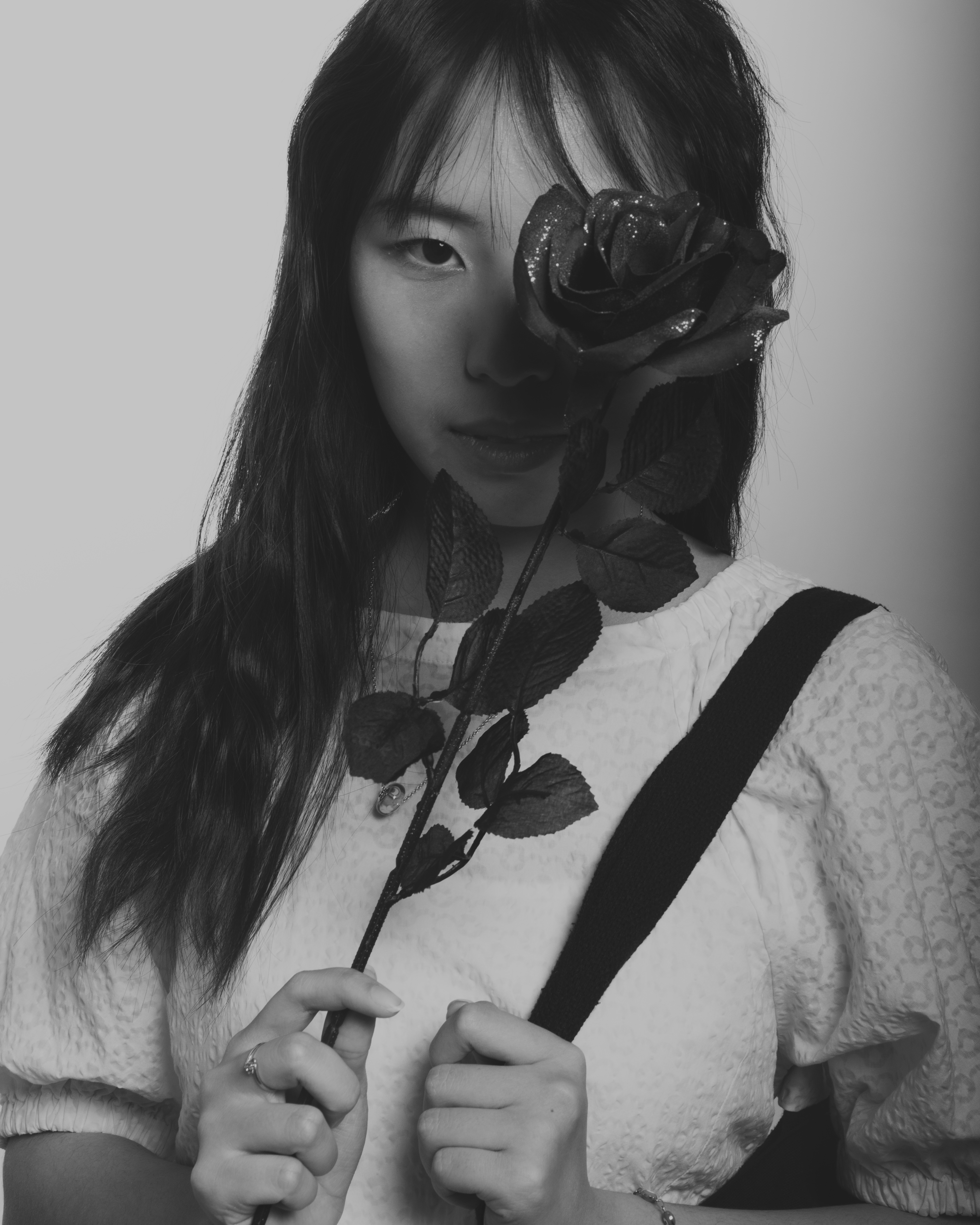 Girl with black rose in a black and white photo